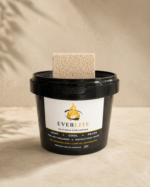 EverLite reusable firelighter black container with stone beside it