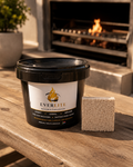 EverLite reusable firelighter in black container beside a lit fireplace